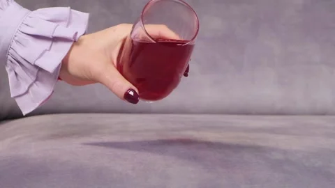 Juice is poured onto a sofa from a glass Video stock 130828133
