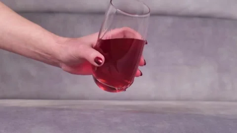 Juice is poured onto a sofa from a glass Stock-Footage 130828176