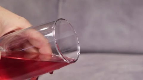 Juice is poured onto a sofa from a glass Video stock 130828414