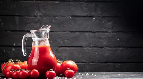 Juice from ripe tomatoes on the table. Stock Photos