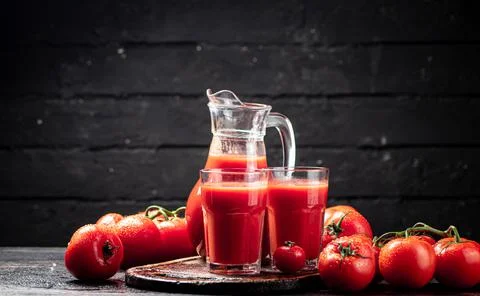 Juice from ripe tomatoes on the table. Stock Photos