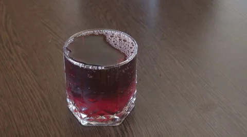 Juice soda flowing in reverse in transparent glass, reverse water effect view Stock Footage 40516390