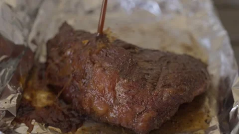 Juice splattered on top of brisket steak slow motion Stock Footage 245369653