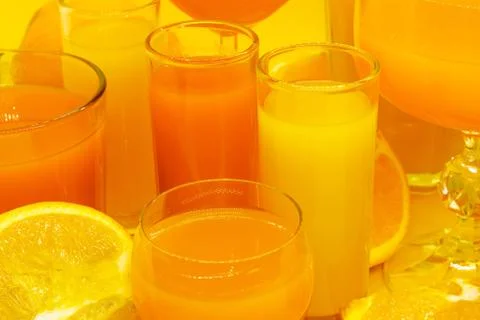 Juice in various shape glasses Stock Photos