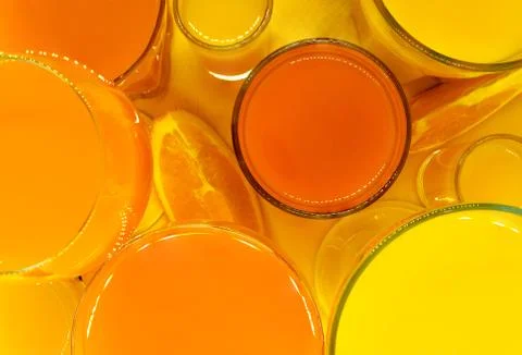Juice in various shape glasses Stock Photos
