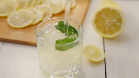 Juice, a young parent absorbed in the process of preparing a mojito lemonade Stock Footage 249109444