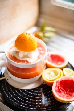 Juicer with citrus fruit squeezed in the kitchen Stock Photos