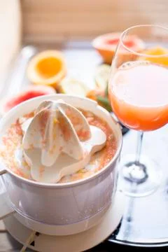Juicer with citrus fruit squeezed in the kitchen Stock Photos