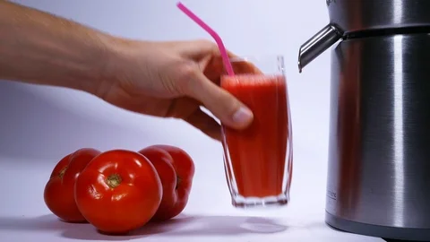 Juicer makes tomato juice from tomatoes. For advertising, studio. Stock Footage 97987350