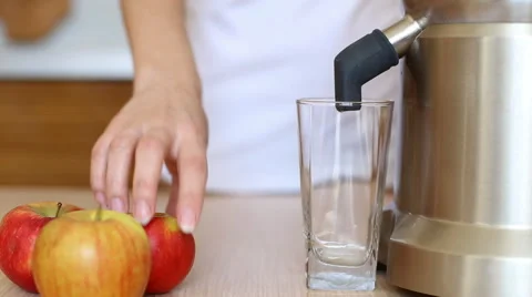 Juicer making apple juice. Close up of Juicing machine, red fruit apples Stock Footage 61177257