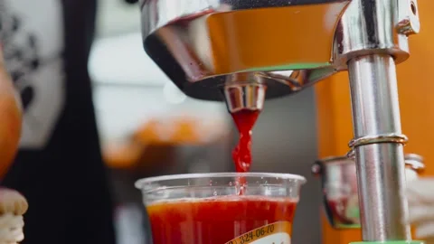 Juicer making fruit juice. Close up of Juicing machine and red juice glass Stock Footage 153592610