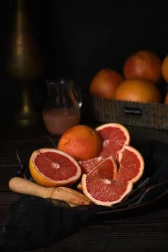 Juicer with squeezed grapefruit half on dish Stock Photos