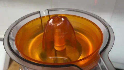 Juicer working inside kitchen food processor in close up, fruit extraction and Stock Footage 337117832