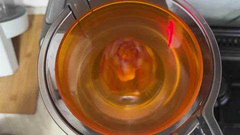 Juicer working inside kitchen food processor in close up, fruit extraction and Stock Footage 337117841