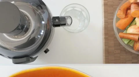 Juicing apples, carrots and celery. UHDTV 4K Stock Footage 46776126