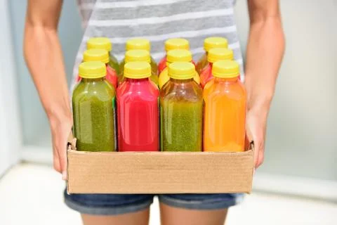 Juicing cold pressed vegetable juices for detox Stock Photos