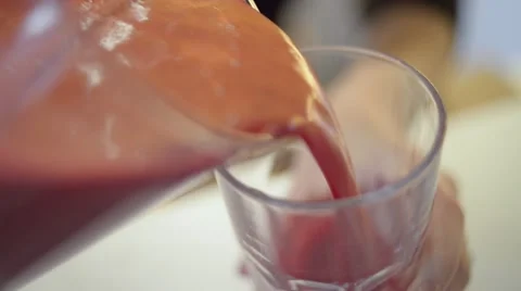 Juicing Fruit and Vegetables: Pouring Juice Stock Footage 45618737