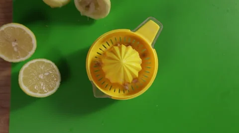 Juicing a lemon top shot close up Stock Footage 64014885