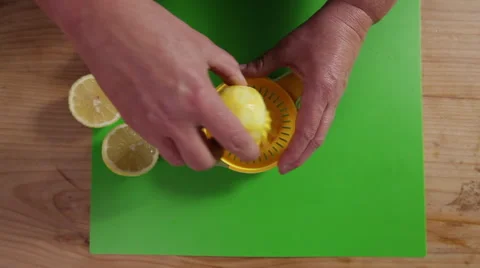 Juicing a lemon; wide top-shot Stock Footage 64014431