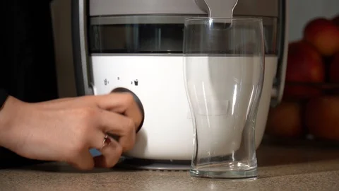 Juicing machine, carrot and apple squeezer Stock Footage 128519653