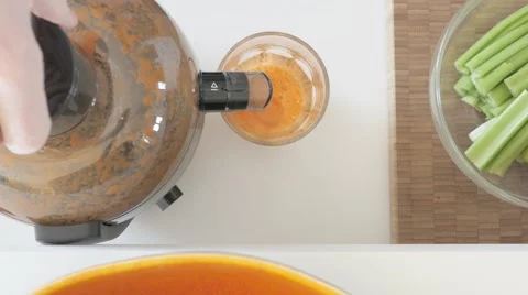 Juicing: Making juice from celery and carrots. UHDTV 4K Stock Footage 46784668