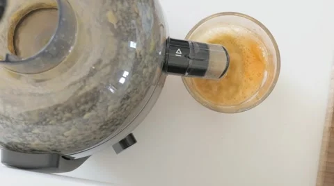 Juicing: Making juice from celery and carrots. Stock Footage 46803874