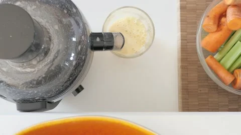 Juicing: Using a juicer machine. UHDTV 4K Stock Footage 46775777