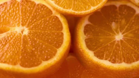 Juicy and appetizing tangerines cut into circles on a black background 4k v.. Stock Footage 261128487