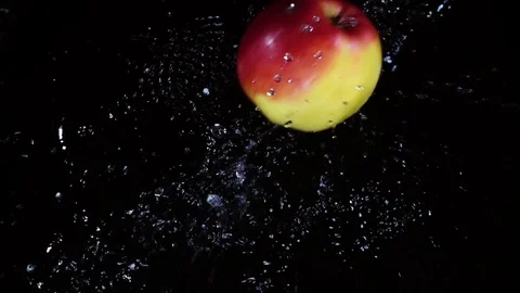 Juicy apple falling and splashing in slow motion. Stock Footage 77021671