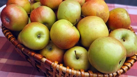 Juicy apples in a wicker basket on the table. Stock Footage 107482939