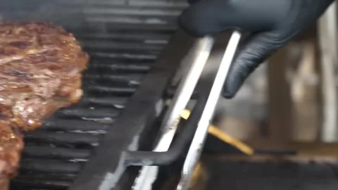 Juicy Barbecue Grilled Tomahawk Steak Sizzling on Grill Video stock 338213220