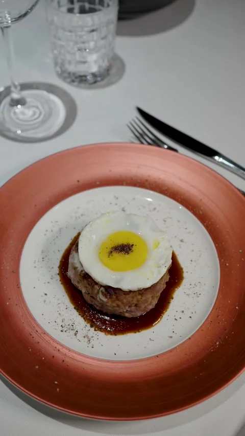 Juicy Beef Burger Steak Topped with Fried Egg and Savory Sauce. A gourmet b.. Video stock 333915210