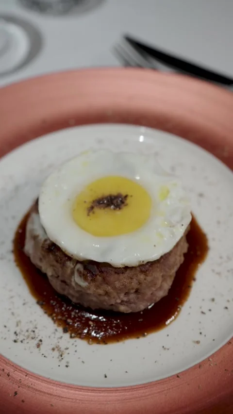 Juicy Beef Burger Steak Topped with Fried Egg and Savory Sauce. A gourmet b.. Stock Footage 333915215