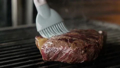 Juicy beef steak is fried on fire coals on grill in the charcoal oven. Stock Footage 153544416