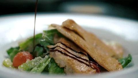 Juicy Caesar salad poured over balsamic vinegar Stock Footage 102661826