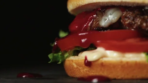 Juicy cheeseburger on black background Stock Footage 121723177