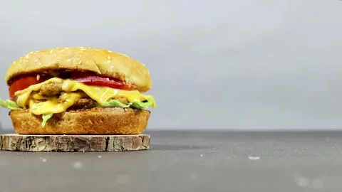 Juicy Cheeseburger With Lettuce Tomato And Melted Cheese On Rustic Wooden Servin Stock Footage 320962258
