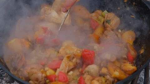 Juicy chicken in a cauldron, slow motion. Frying chicken in a cauldron Stock Footage 280213836