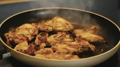 Juicy Chicken Frying in Pan Stock Footage 321429005