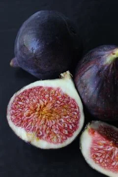 Juicy Fig slices on a dark background.Texture or background 写真素材