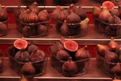 Juicy figs in plastic containers, displayed at a Spanish market Stock Photos