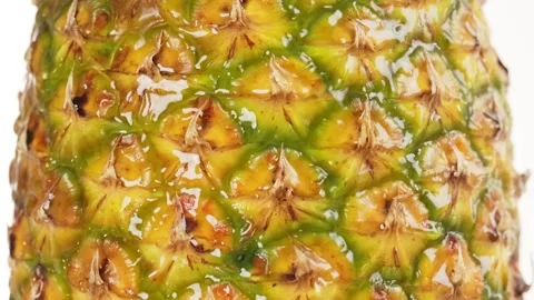 Juicy fresh pineapple in close-up view with water flowing on the skin. Perf.. Stock Footage 314431266