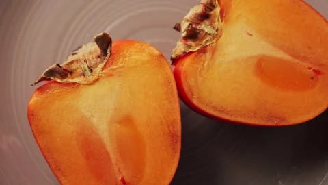 Juicy fresh sweet persimmon. Source of antioxidants and vitamins. Stock Footage 300585737