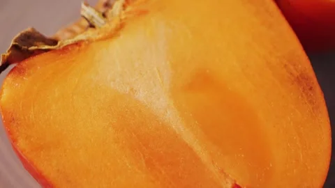 Juicy fresh sweet persimmon. Source of antioxidants and vitamins. Stock Footage 323314945