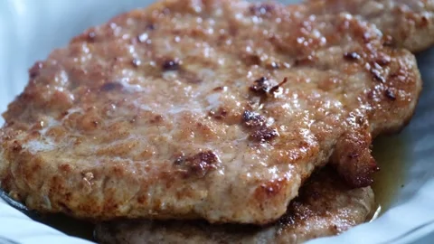 Juicy Fried Pork Cutlets Closeup with Crispy Texture on Plate Stock Footage 335718346