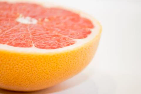 Juicy grapefruit close up view on white background Stock Photos