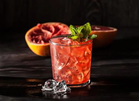Juicy grapefruit drink on dark table Stock Photos