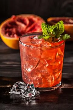 Juicy grapefruit drink on dark table Stock Photos