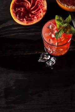 Juicy grapefruit drink on dark table Stock Photos
