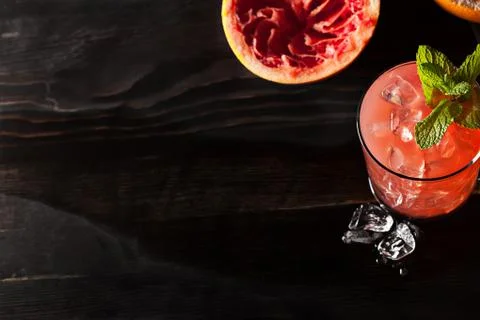 Juicy grapefruit drink on dark table Stock Photos